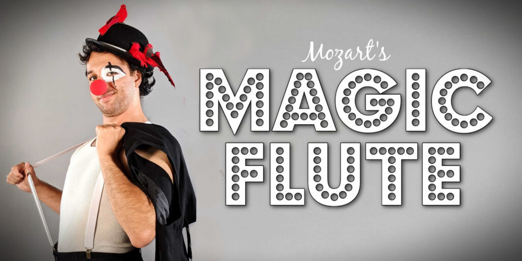 Publicity banner for Mozart's Magic Flute featuring man in suspenders and bowler hat